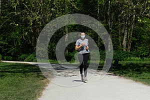 Woman running in park with a face mask