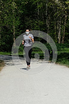 Woman running in park with a face mask