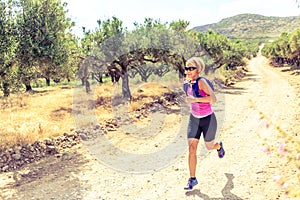 Woman running on path, Crete Island, Greece