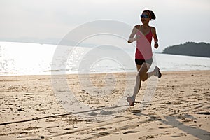 woman running on sandy beach