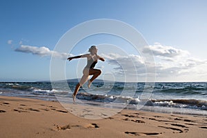 Woman running silhouette. Run on sea. Sport exercise at beach concept.