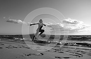 Woman running silhouette. Run on sea. Sport exercise at beach concept.