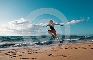 Woman running silhouette. Run on sea. Sport exercise at beach concept.