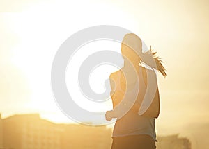 Woman, running and silhouette in sunrise for exercise with mockup space in sky with buildings in city. Girl, person and