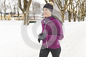 Woman Running in Snowy Park in winter season