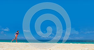 Woman running on summer beach