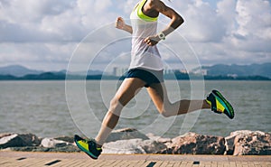 Woman running on sunny coast