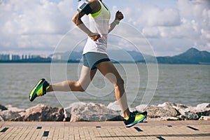 Woman running on sunny coast