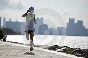 Woman running on sunny coast