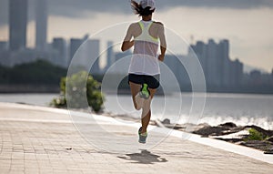 Woman running on sunny coast