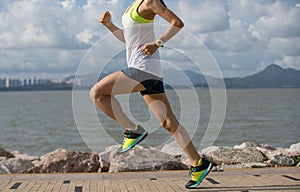 Woman running on sunny coast