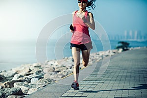 Woman running on sunny coast