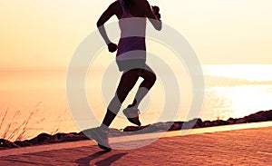 Woman running on sunny coast