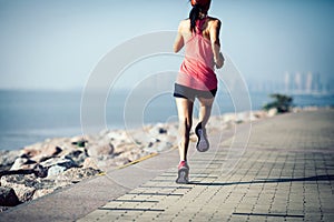 Woman running on sunny coast