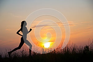 Woman running at sunset