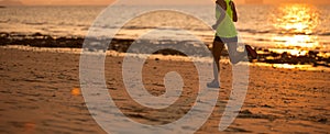 woman running at sunset sandy beach