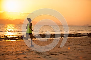woman running at sunset sandy beach