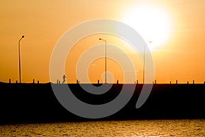 Woman is running in sunset (silhouette)