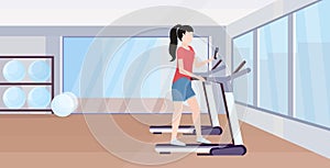 Woman running on treadmill girl using smartphone while training workout digital gadget addiction concept modern gym