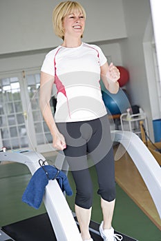 Woman Running On Treadmill At Gym