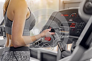 Woman running on treadmill in gym
