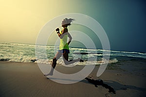 Woman running on tropical beach