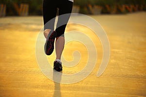 Woman running under sunrise