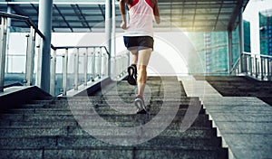 Woman running up city stairs