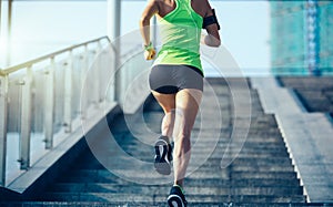 Woman running up city stairs