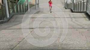 Woman running up city stairs