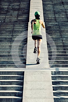 Woman running up city stairs