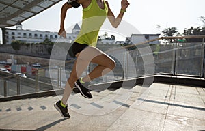 Woman running up city stairs jogging