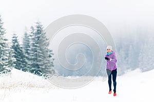 Woman running on winter trail, fitness inspiration and motivation