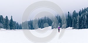 Woman running on winter trail, fitness inspiration and motivation