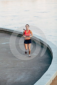 Woman runnning along granite curved parapet photo