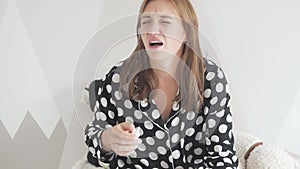 Woman with a Runny Nose Using a Nasal Spray