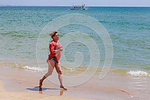 Woman runs along the seashore