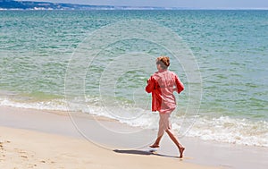Woman runs along the seashore