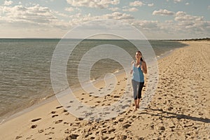 Woman runs along water