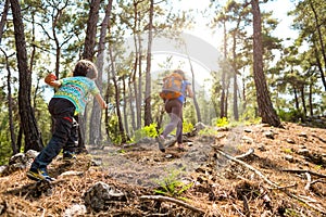 A woman runs with a child on a forest road