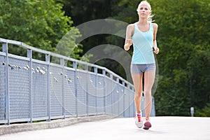 Woman runs outdoor on a bridge as stamina training photo