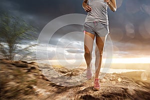 Woman runs in a rocky landscape