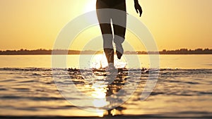 Woman Runs into Shallow Water at Golden Sunset on the Beach. Slow Motion 240 fps