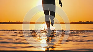 Woman Runs into Shallow Water at Golden Sunset on the Beach. Slow Motion 240 fps