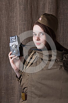 Woman in Russian military uniform with camera. Female war correspondent during the second world war.