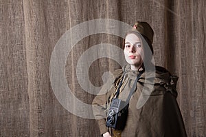 Woman in Russian military uniform with camera. Female war correspondent during the second world war.