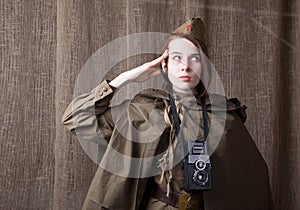 Woman in Russian military uniform with camera. Female war correspondent during the second world war.