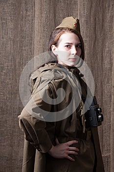 Woman in Russian military uniform with camera. Female war correspondent during the second world war.