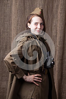 Woman in Russian military uniform with camera. Female war correspondent during the second world war.