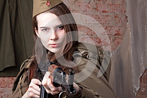 Woman in Russian military uniform shoots a rifle. Female soldier during the second world war.